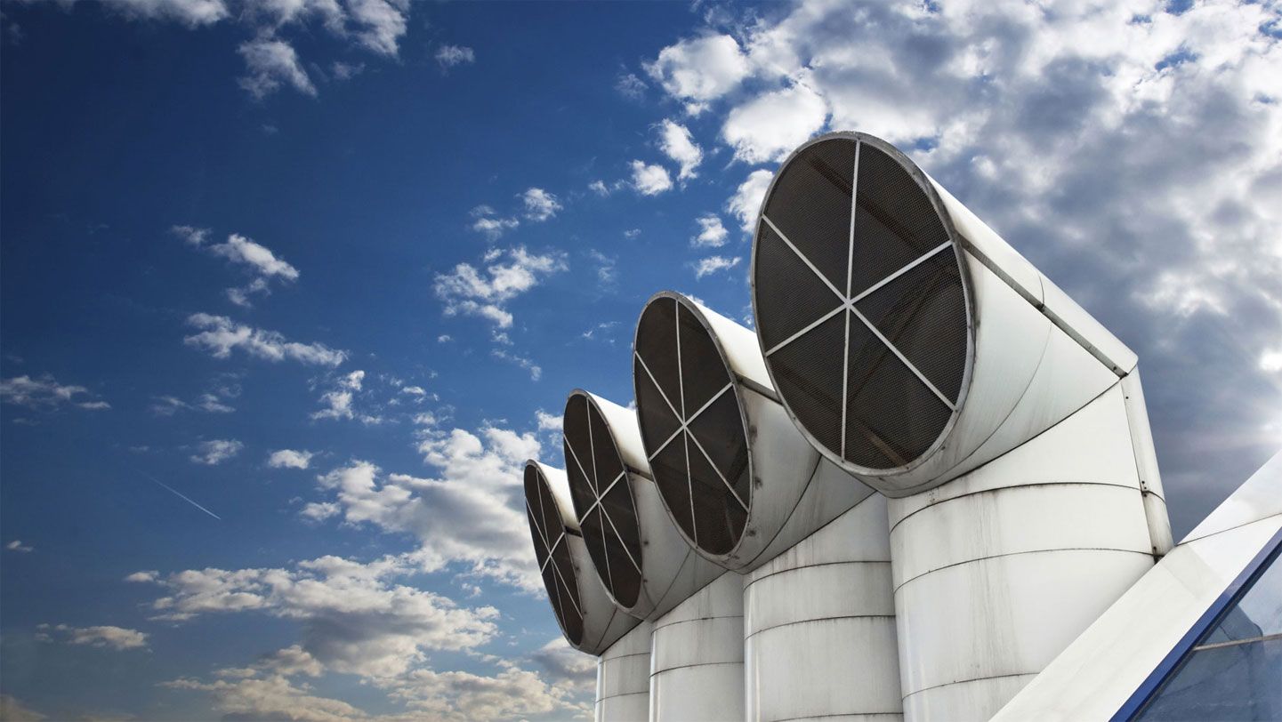 Industrial exhaust fans against a blue sky
