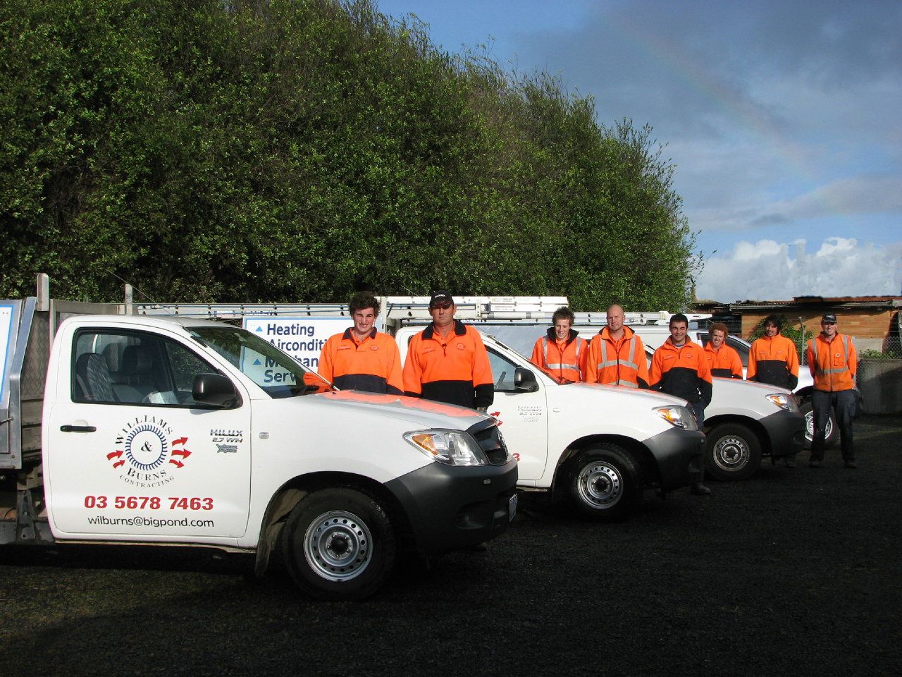 Williams & Burns team with service vehicles