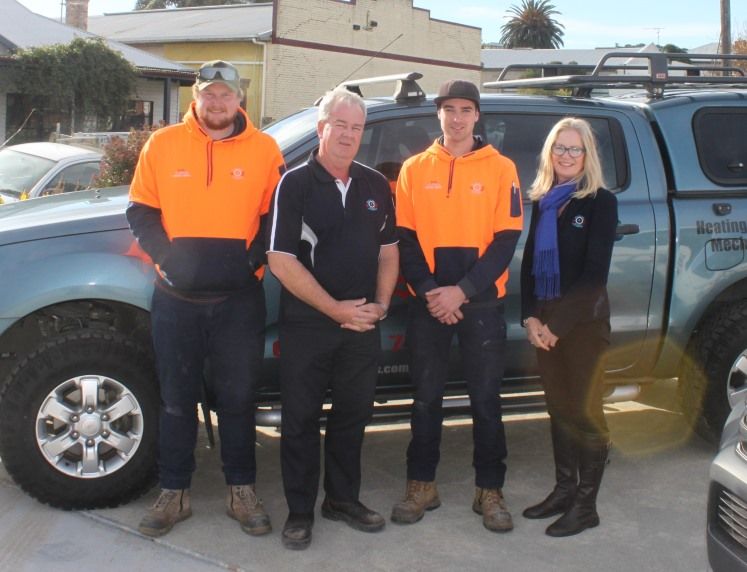 Williams & Burns technicians beside a service ute